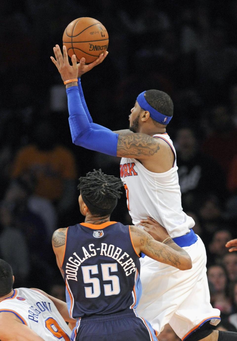 New York Knicks' Carmelo Anthony, right, puts up a shot as he gets by Charlotte Bobcats' Chris Douglas-Roberts (55) during the fourth quarter of an NBA basketball game Friday, Jan. 24, 2014, at Madison Square Garden in New York. The shot gave Anthony 62 points for a Garden record as the Knicks won 125-96. (AP Photo/Bill Kostroun)