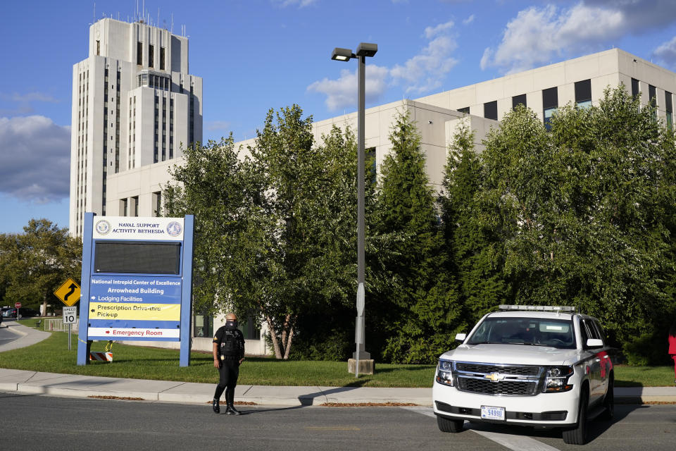 A police officer blocks a road before President Donald Trump arrives at Walter Reed National Military Medical Center, in Bethesda, Md., Friday, Oct. 2, 2020, after he tested positive for COVID-19. (AP Photo/Jacquelyn Martin)