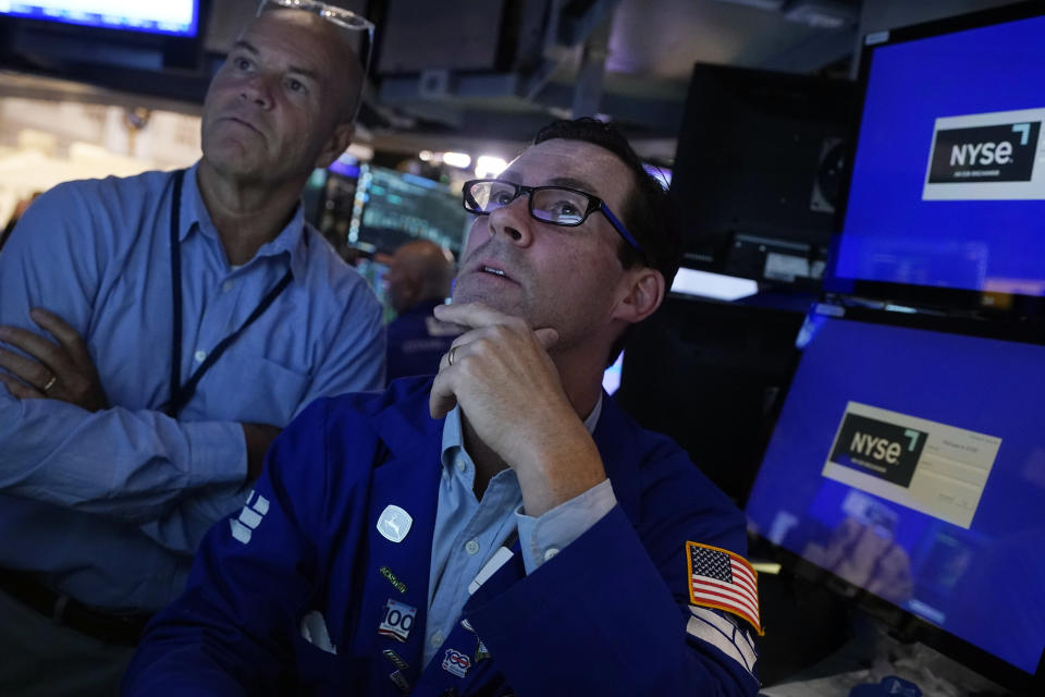 Specialist John McNierney, right, works with a colleague on the floor of the New York Stock Exchange, Wednesday, Aug. 7, 2024. (AP Photo/Richard Drew)