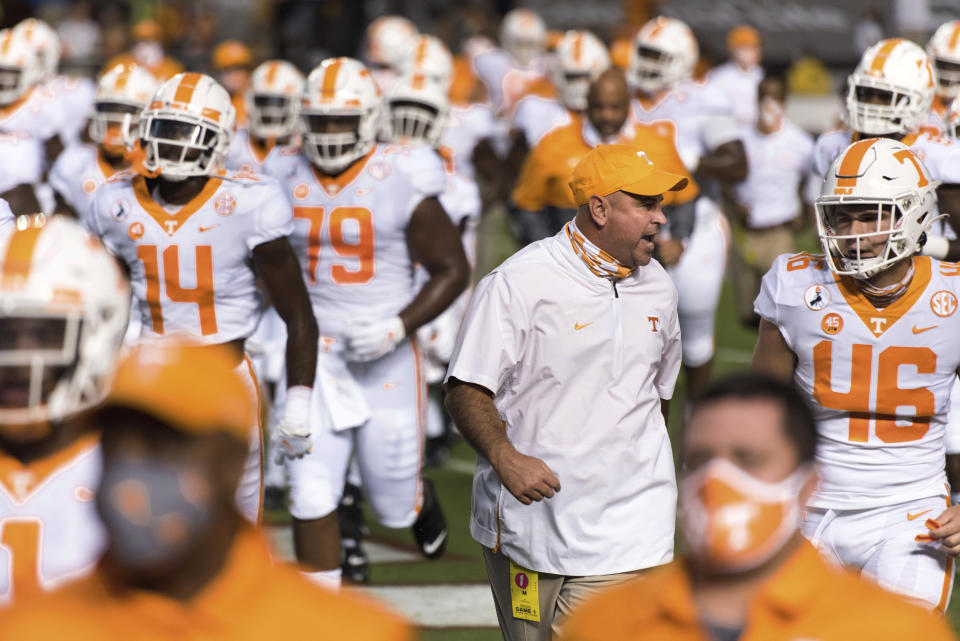 Tennessee coach Jeremy Pruitt talks with Will Albright (46) before the team's NCAA college football game against South Carolina on Saturday, Sept. 26, 2020, in Columbia, S.C. (AP Photo/Sean Rayford)