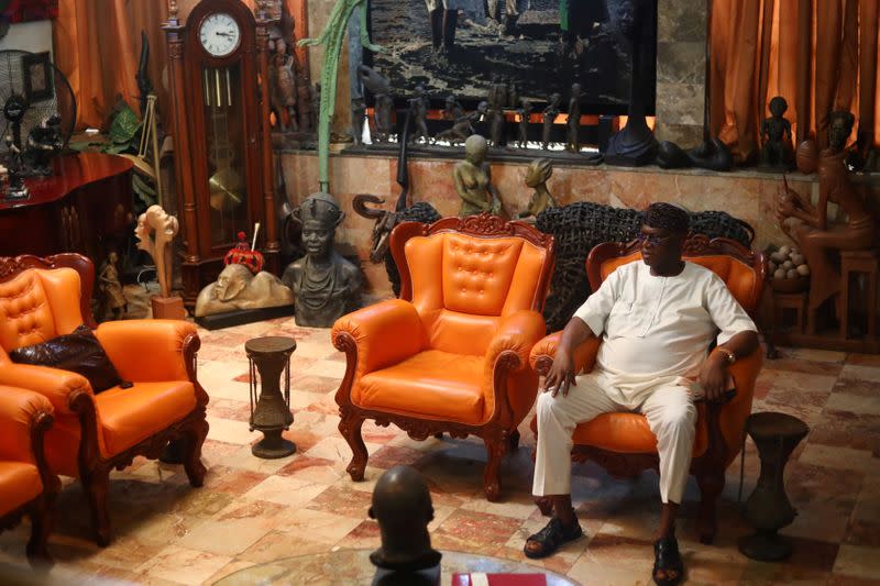 Yemisi Shyllon, a Nigerian art collector, sits on a chair in his living room decorated with numerous artefacts and artworks, in Lagos