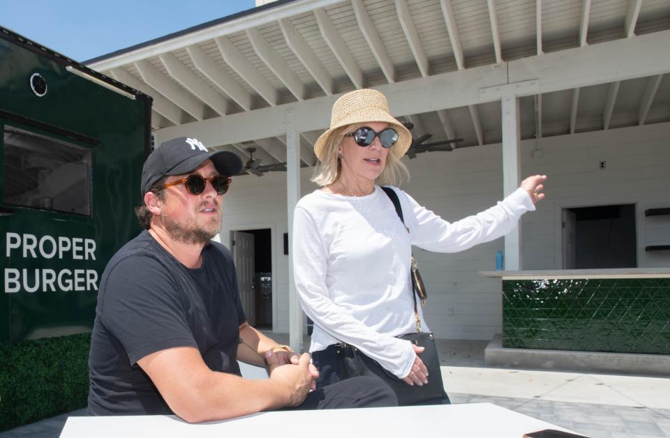 Raf Simpson, co-founder of the Artisan Restaurant Group, left, listens as Teri Levin, B Side co-owner, talks about the new outdoor venue beside Vinyl Music Hall along Garden Street in downtown Pensacola on Wednesday, July 5, 2023.