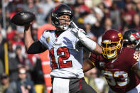 Tampa Bay Buccaneers quarterback Tom Brady (12) throws under pressure from Washington Football Team defensive tackle Jonathan Allen (93) during the first half of an NFL football game, Sunday, Nov. 14, 2021, in Landover, Md. (AP Photo/Mark Tenally)