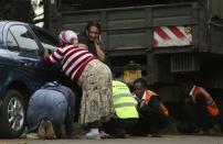 People take cover after hearing gun shots near the Westgate shopping centre in Nairobi September 23, 2013. REUTERS/Karel Prinsloo