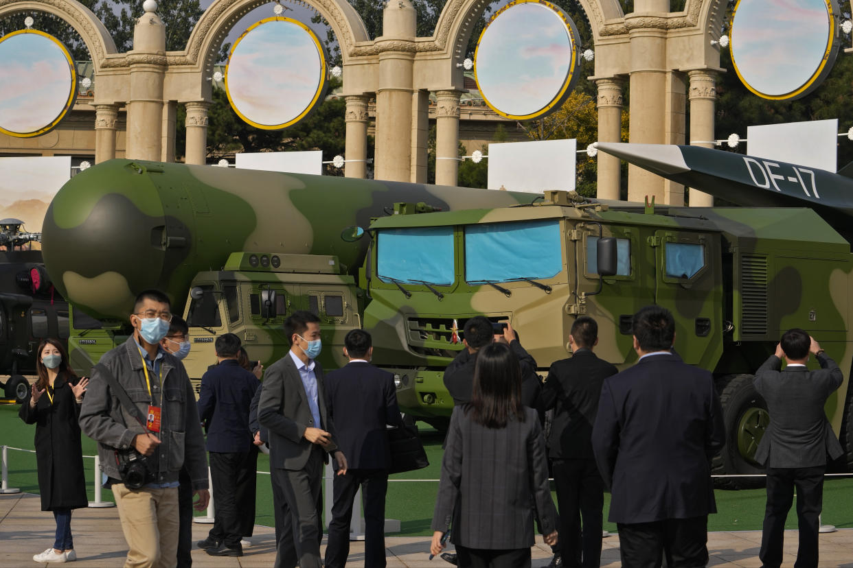 Visitors tour past military vehicles carrying the Dong Feng 41 and DF-17 ballistic missiles at an exhibition highlighting President Xi Jinping and his China's achievements under his leadership, at the Beijing Exhibition Hall in Beijing on Oct. 12, 2022. China strictly adheres to its policy of no first use of nuclear weapons "at any time and under any circumstances," its Defense Ministry said Tuesday, Dec. 6, 2022, in a scathing response to a U.S. report alleging a major buildup in Beijing's nuclear capabilities. (AP Photo/Andy Wong)