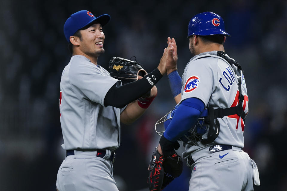 Chicago Cubs Seiya Suzuki (27) and Willson Contreras (40) celebrate after the Cubs defeated the Atlanta Braves 6-3 in a baseball game Wednesday, April 27, 2022, in Atlanta. (AP Photo/John Bazemore)