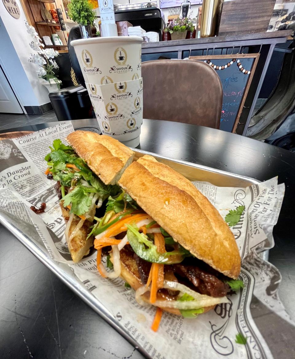 Savour Coffee's banh mi features marinated grilled pork, pickled daikon and carrot, jalapeno, cilantro, cucumber and five-spice aioli.