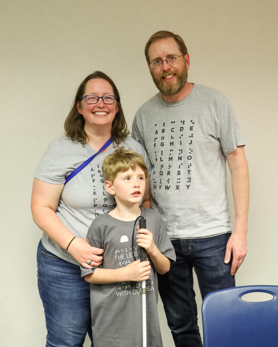 Peter Heath, the young author, stands with his parents, Beth and Joe.