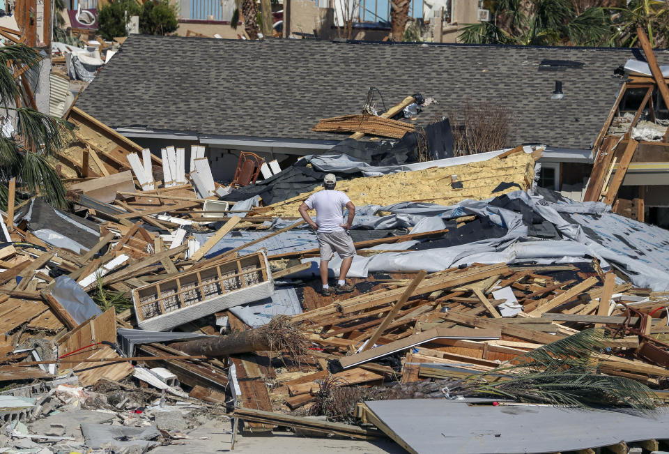 Jay Faulk, 56, surveys the damage to his home, Friday, Oct. 12, 2018 in Mexico Beach, Fla. Residents of the small beach town of Mexico Beach began to make their way back to their homes some for the first time after Hurricane Michael made landfall Wednesday. (Chris Urso/Tampa Bay Times via AP)