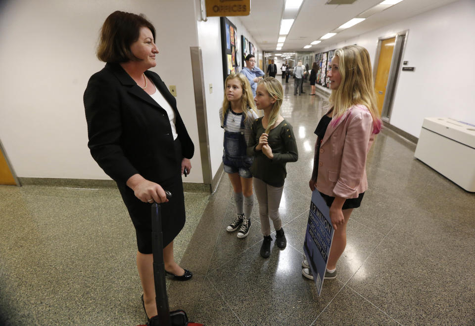 Ava Kotler, 12, right, her sister Kirra, 10, second from right, and Lizzie Gordon, 11, talk with Assembly Speaker-elect Toni Atkins, D-San Diego, urging her support for a bill to ban the holding of killer whales for performance and entertainment purposes, Monday, April 7, 2014, at the Capitol in Sacramento, Calif. Supporters of the bill, AB2140 delivered more than 1 million signatures calling for its passage to Assembly Anthony Rendon, D-Lakewood, chairman Assembly Water, Parks and Wildlife Committee where the bill will be heard, Tuesday.(AP Photo/Rich Pedroncelli)