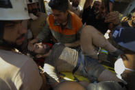 A survivor is taken out of the rubble after a massive explosion in Beirut, Lebanon, Wednesday, Aug. 5, 2020. (AP Photo/Hassan Ammar)