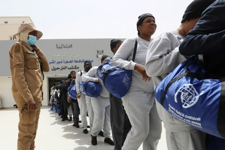 Nigerian migrants queue as they wait to be deported from Libya (Mahmud Turkia)