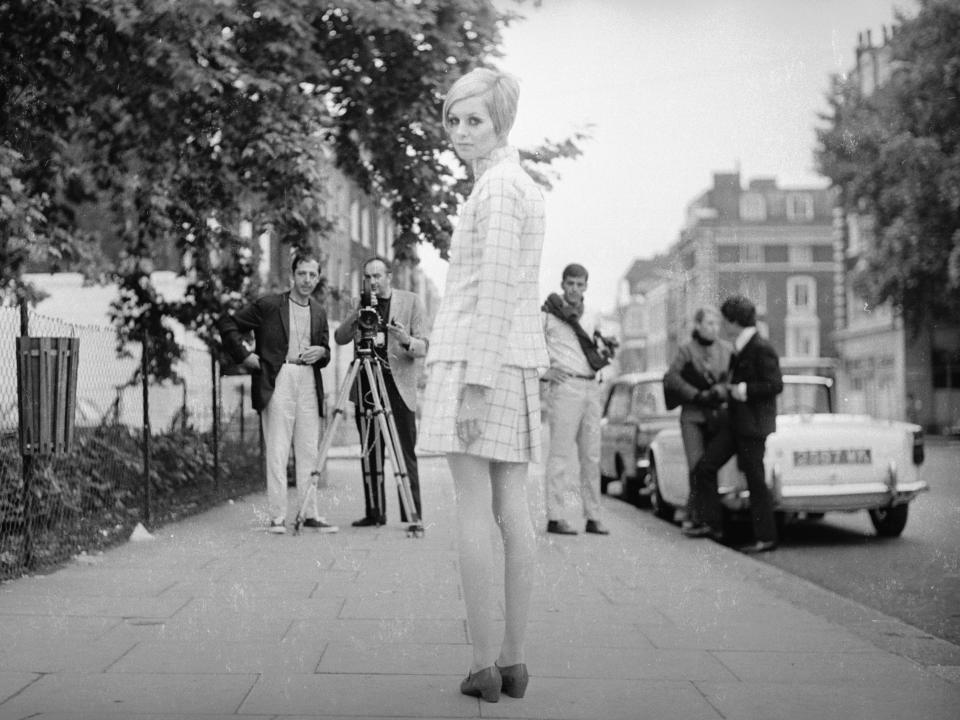 Twiggy modeling a pleated miniskirt and blazer on the Kings Road in London on June 12, 1966.