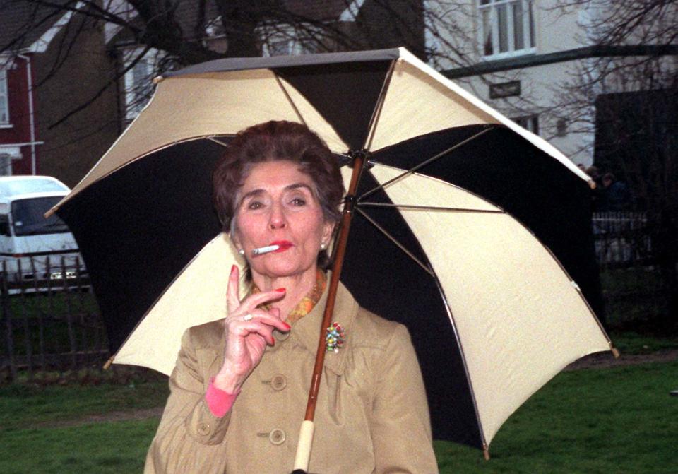 June Brown as Dot Cotton smoking a cigarette.