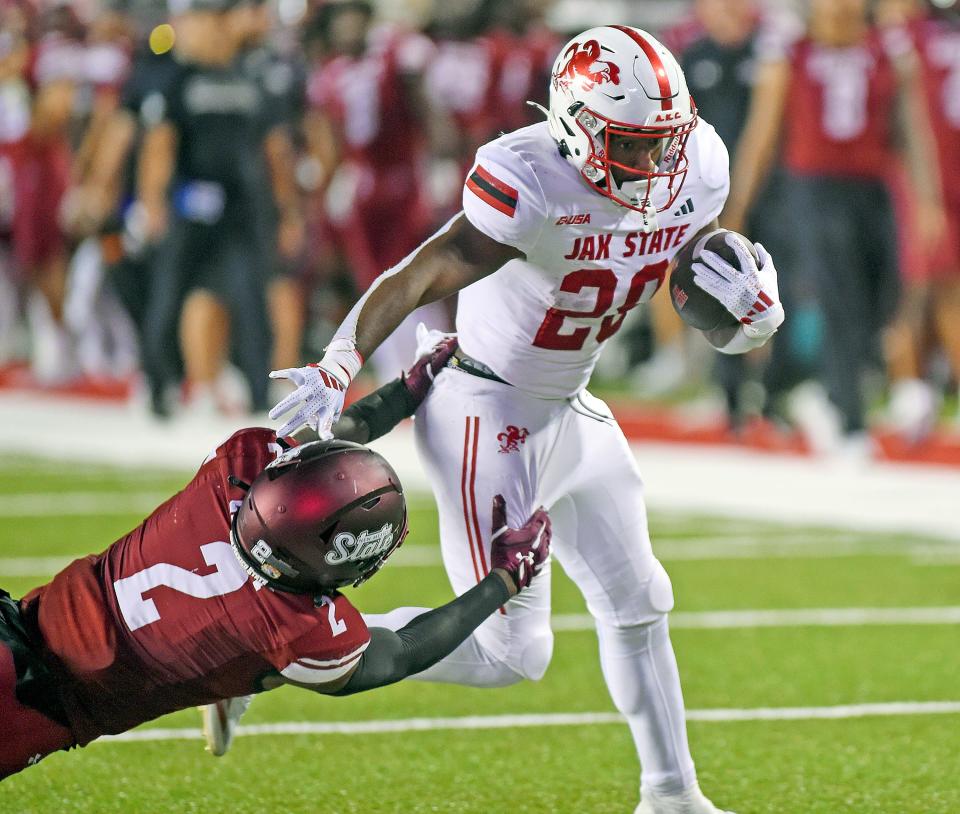 Jacksonville State's Tre Stewart tries to evade the tackle of NM State's Da'Marcus Crosby during college football action at AmFirst Stadium in Jacksonville, Alabama October 9, 2024. (Dave Hyatt / Special to the Gadsden Times)