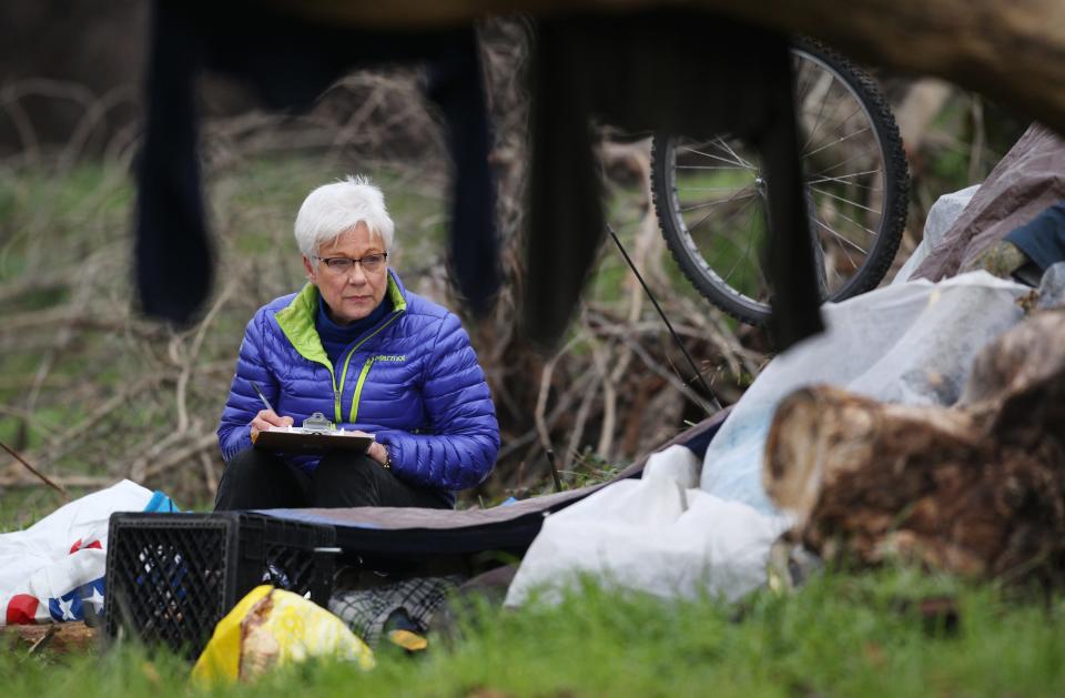 Judy Salter talks to a person in January 24, 2017 living in the Henderson Open Space in Redding during the Point In Time homeless count.