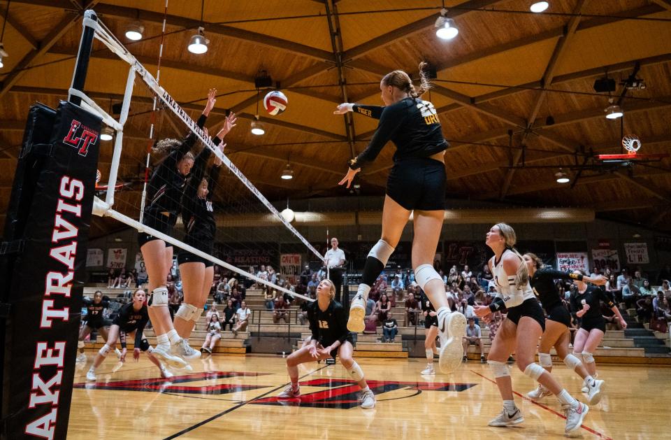 Dripping Springs outside hitter Henley Anderson sends a shot over the net during the Tigers' four-set loss Tuesday night to Lake Travis.