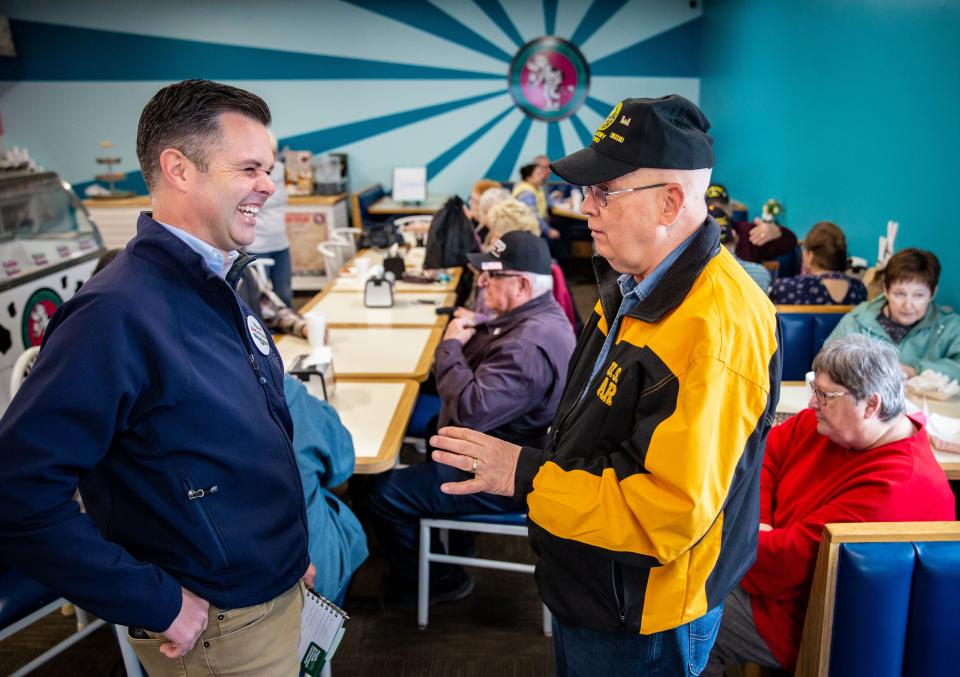 Campaigning for Iowa's 3rd District congressional seat on April 8, state Sen. Zach Nunn, left, chats with retired U.S. Army Sgt. Major Stephen Croft at Main Street Donuts in Ottumwa.