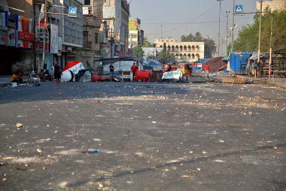 Anti-government protesters gather by barriers near Tahrir square, Baghdad, Iraq, Monday, July, 27, 2020. Fresh violence erupted between demonstrators and security forces in central Baghdad, human rights monitors and Iraqi security and health officials said on Monday, following months of quiet in the wake of the coronavirus pandemic. (AP Photo/Khalid Mohammed)