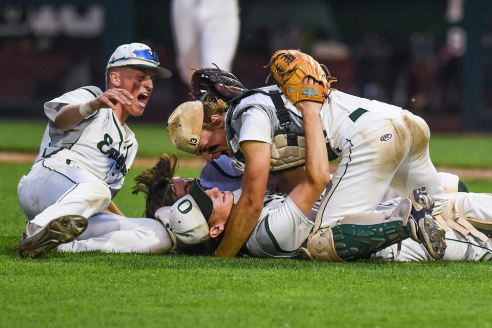 From left, Olivet's Charlie Anderson, Cam Frazier and Jake Miller celebrate after beating Grand Ledge to win the Diamond Classic championship on Monday, June 5, 2023, at McLane Stadium on the Michigan State University campus in East Lansing.