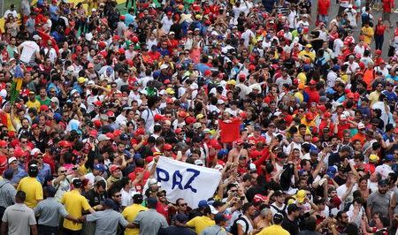 Formula One fans hold up a banner that reads "Peace" after the Brazilian F1 Grand Prix in Sao Paulo, Brazil, November 15, 2015. REUTERS/Nacho Doce