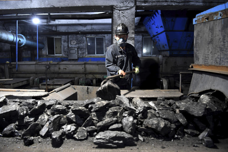 FILE - In this photo released by Xinhua News Agency, a worker sort coals at Qianyingzi coal mine in Suzhou, east China's Anhui Province on Oct. 20, 2021. Chinese President Xi Jinping promised a "proactive and steady" approach to reducing climate-changing carbon emissions, but at the same time the ruling party is increasing coal production to avert a repeat of last year's power shortages and blackouts. (Han Xu/Xinhua via AP, File)