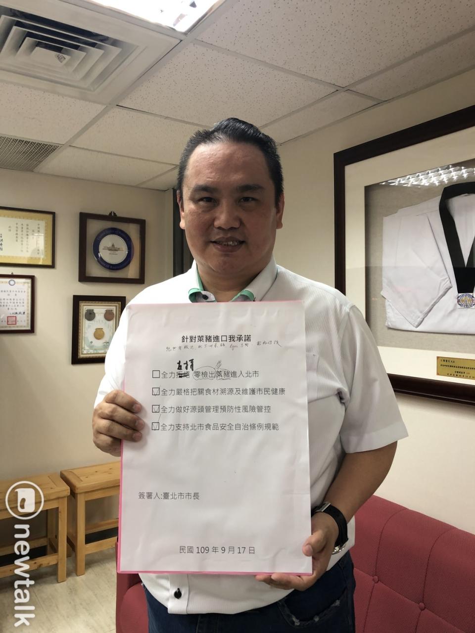 國民黨團書記長陳重文出示要求台北市長柯文哲簽署的承諾書。   圖：陳重文辦公室 / 提供