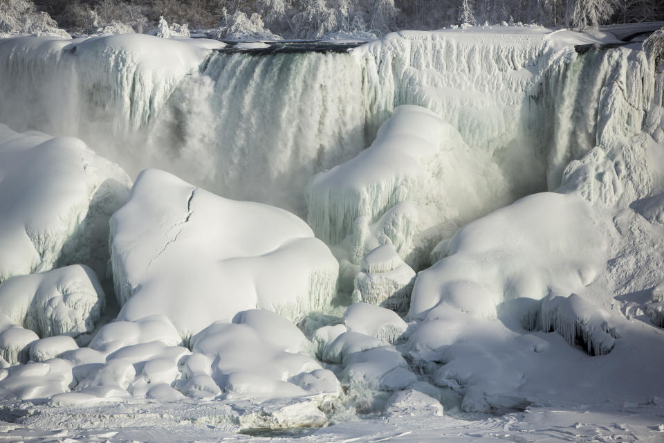 A partially frozen American Falls in sub freezing temperatures is seen in Niagara Falls, Ontario February 17, 2015. Temperature dropped to 6 degrees Fahrenheit (-14 Celsius) on Tuesday. The National Weather Service has issued Wind Chill Warning in Western New York from midnight Wednesday to Friday.   REUTERS/Lindsay DeDario  (CANADA - Tags: TRAVEL ENVIRONMENT)