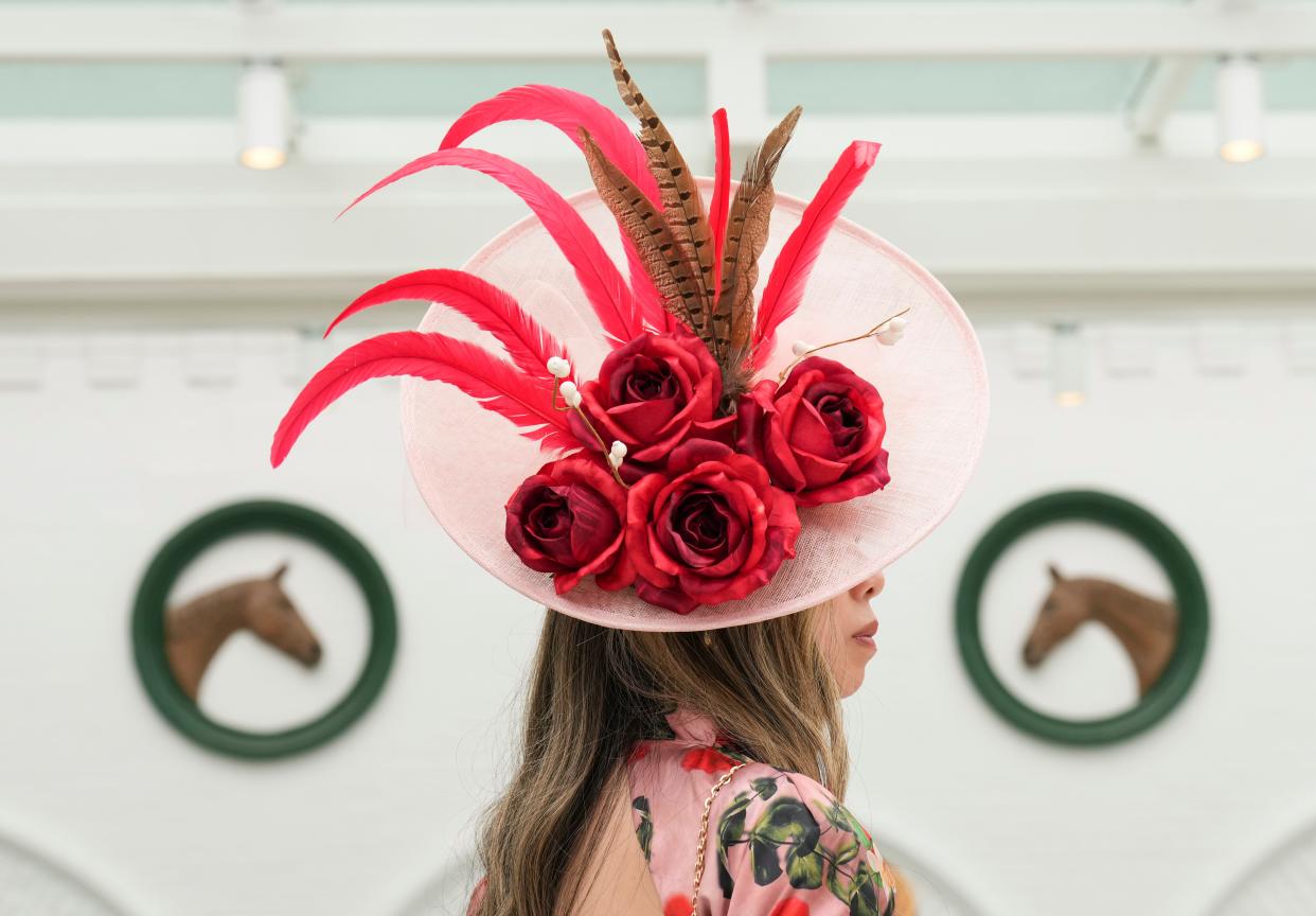 Ann Huynh of Jeffersonville takes a break on the second level of the Paddock on Kentucky Oaks Friday, May 3, 2024 in Louisville, Kentucky.