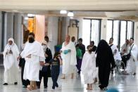 Muslim pilgrims wear protective face masks to prevent contracting coronavirus, as they arrive at the Grand mosque in the holy city of Mecca