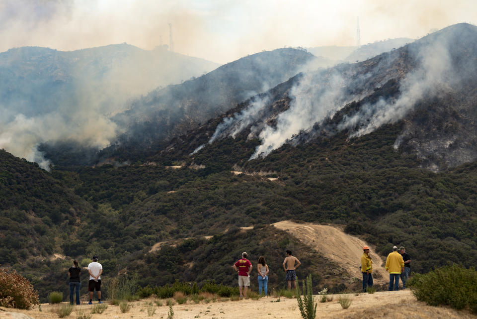 People watch the La Tuna Canyon fire