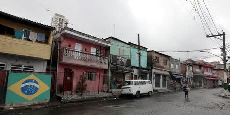 A woman walks along a street in Jardim Sao Luis near the edge of Sao Paulo September 4, 2014. REUTERS/Paulo Whitaker