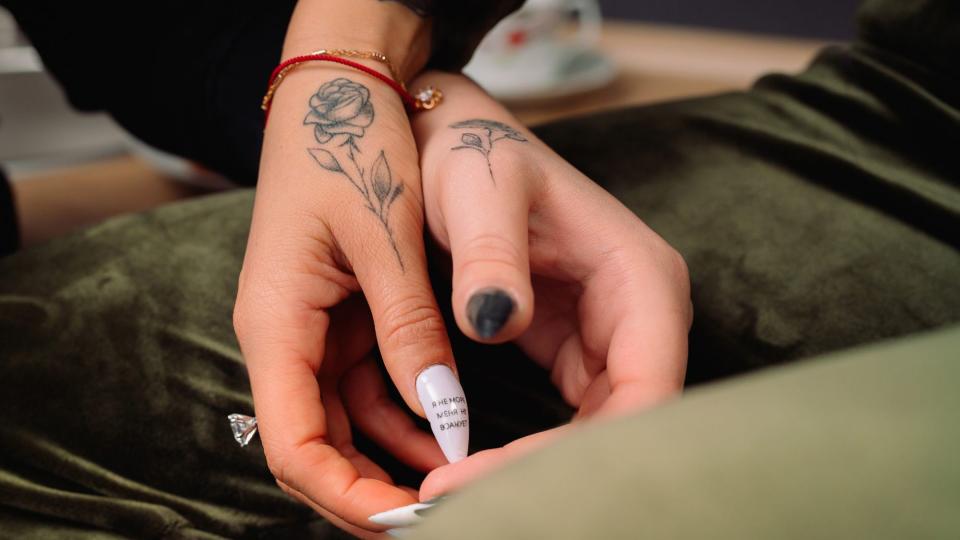 Hands with matching roses couples tattoos