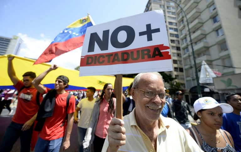 Venezuelan opposition activists shout slogans during a protest against the government of President Nicolas Maduro on April 6, 2017 in Caracas