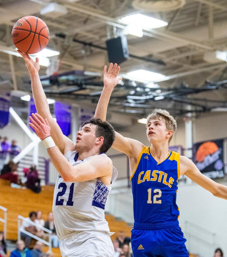 South's Zach Sims (21) shoots past Castle's Xander Niehuas (12) during the Bloomington South versus Castle boys basketball game at Bloomington High School South on Friday, Jan. 20, 2023.