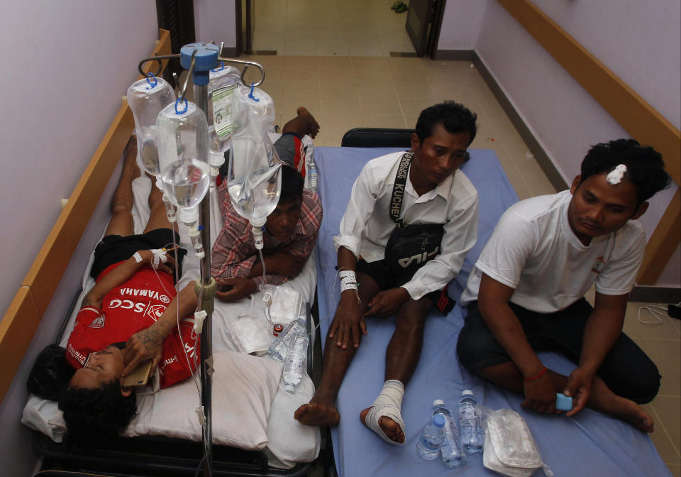 Victims from the site of a collapsed building are treated at a hospital in Preah Sihanouk province, Cambodia, Saturday, June 22, 2019. A seven-story building under construction collapsed in Cambodia's coastal city of Sihanoukville early Saturday, killing seven workers and injuring 21, authorities said. (AP Photo/Heng Sinith)