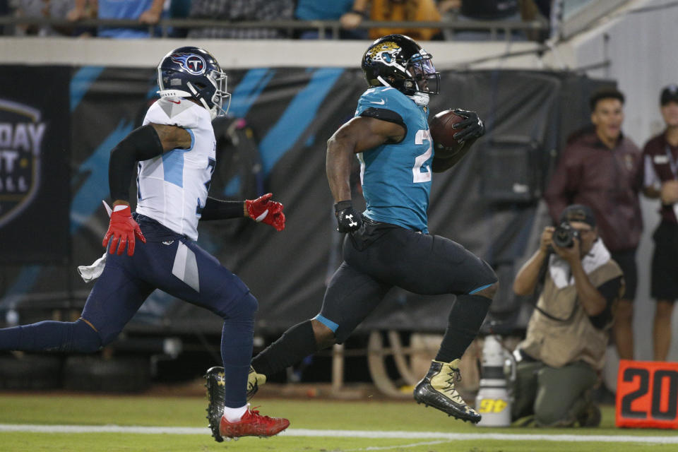 Jacksonville Jaguars running back Leonard Fournette, right, runs away from Tennessee Titans free safety Kevin Byard for a 69-yard gain during the second half of an NFL football game, Thursday, Sept. 19, 2019, in Jacksonville, Fla. (AP Photo/Stephen B. Morton)