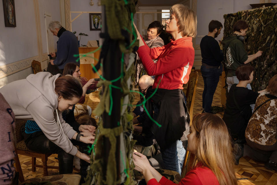 Volunteers at a library in central Lviv, Ukraine, weave camouflage nets to send to the soldiers on the front lines on March 7.<span class="copyright">Natalie Keyssar for TIME</span>