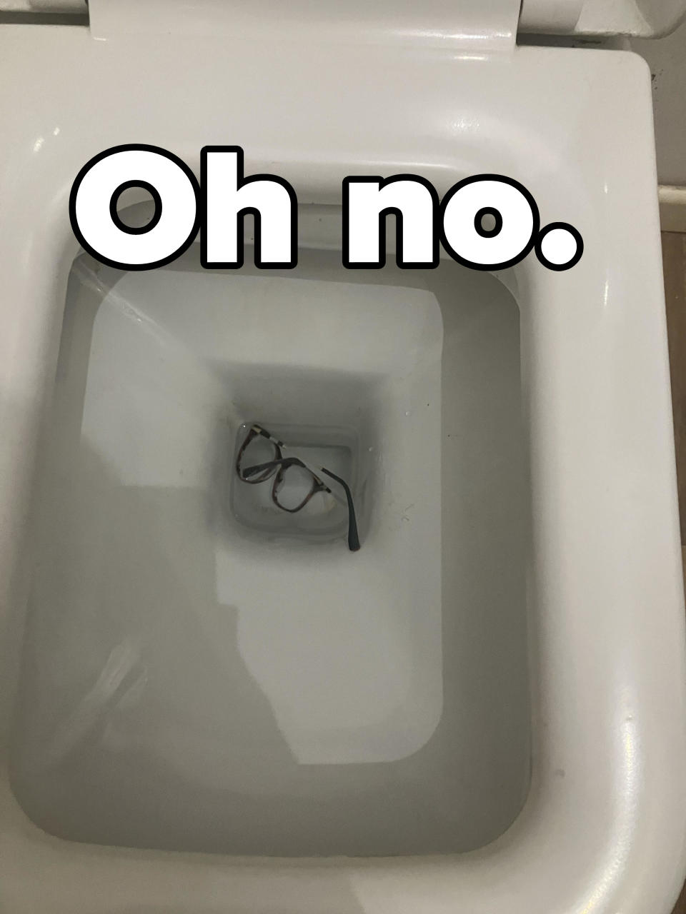 A pair of eyeglasses in the toilet