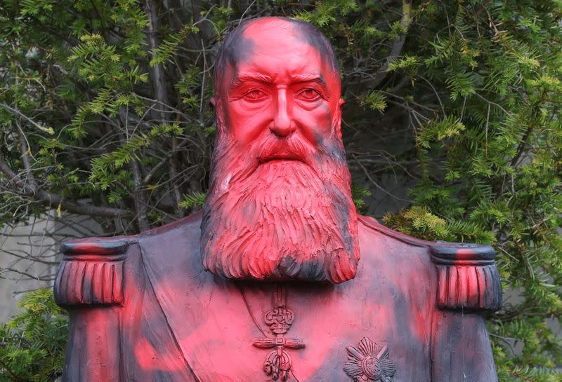 A statue of former Belgian King Leopold II sprayed with a graffiti is seen in the park of the Africa Museum, in Tervuren