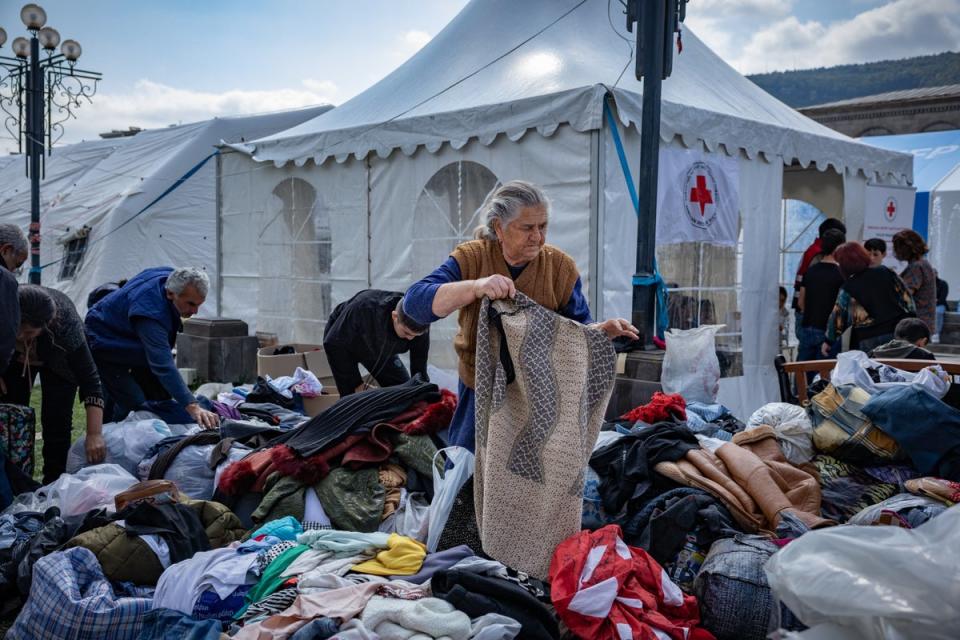 Refugees pick through  donated clothes as they were forced to leave everything behind when fleeing Nagorno Karabakh (Bel Trew)