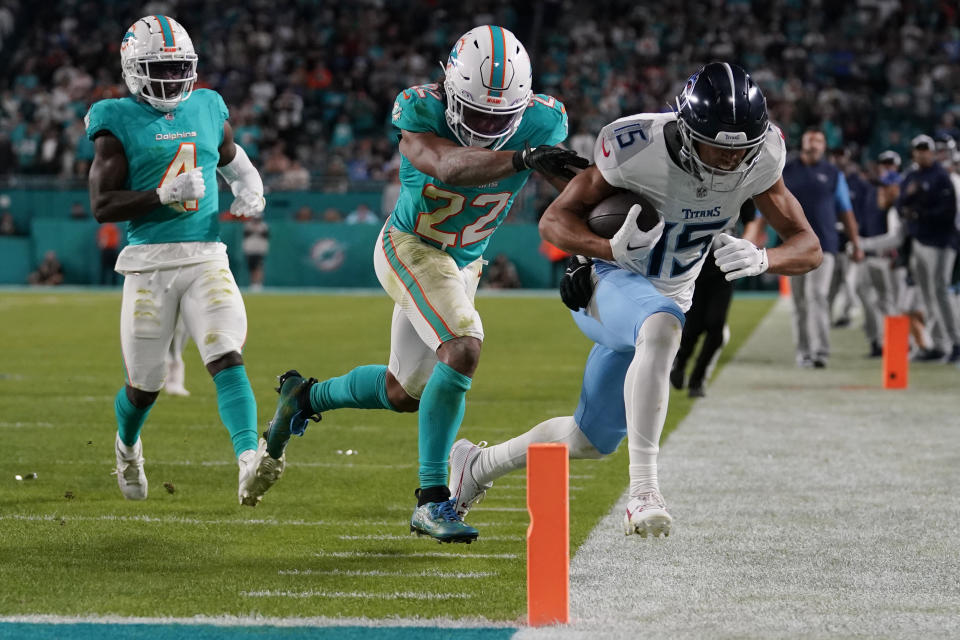 Tennessee Titans wide receiver Nick Westbrook-Ikhine (15) is pushed out of bounds by Miami Dolphins safety Elijah Campbell (22) during the second half of an NFL football game, Monday, Dec. 11, 2023, in Miami. (AP Photo/Lynne Sladky)