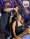 <p>"This week for the ballroom Carrie Ann went for a snatched long pony tail," says hairstylist <a href="https://www.instagram.com/glennnutley/" rel="nofollow noopener" target="_blank" data-ylk="slk:G;elm:context_link;itc:0;sec:content-canvas" class="link ">G</a><a href="https://www.instagram.com/glennnutley/" rel="nofollow noopener" target="_blank" data-ylk="slk:lenn Nutley;elm:context_link;itc:0;sec:content-canvas" class="link ">lenn Nutley</a>. "I pulled her hair back and wrapped the base in elastic before adding the extra length. Then, I ironed all the hair with the <a href="https://www.dermstore.com/product_Ceramic+Flat+Styling+Iron+125+Inch_70407.htm" rel="nofollow noopener" target="_blank" data-ylk="slk:Harry Josh Pro Tools Ceramic Flat Styling Iron;elm:context_link;itc:0;sec:content-canvas" class="link ">Harry Josh Pro Tools Ceramic Flat Styling Iron</a>."</p> <p>"To make the gold pony, I first wrapped the base with black electrical tape to create an even foundation, then I covered that with gold foil tape and finished by using gold craft wire to bend around it to create a cage-like effect."</p>
