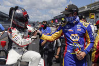 Marco Andretti is congratulated by Alexander Rossi after Andretti won the pole for the Indianapolis 500 auto race at Indianapolis Motor Speedway, Sunday, Aug. 16, 2020, in Indianapolis. (AP Photo/Darron Cummings)