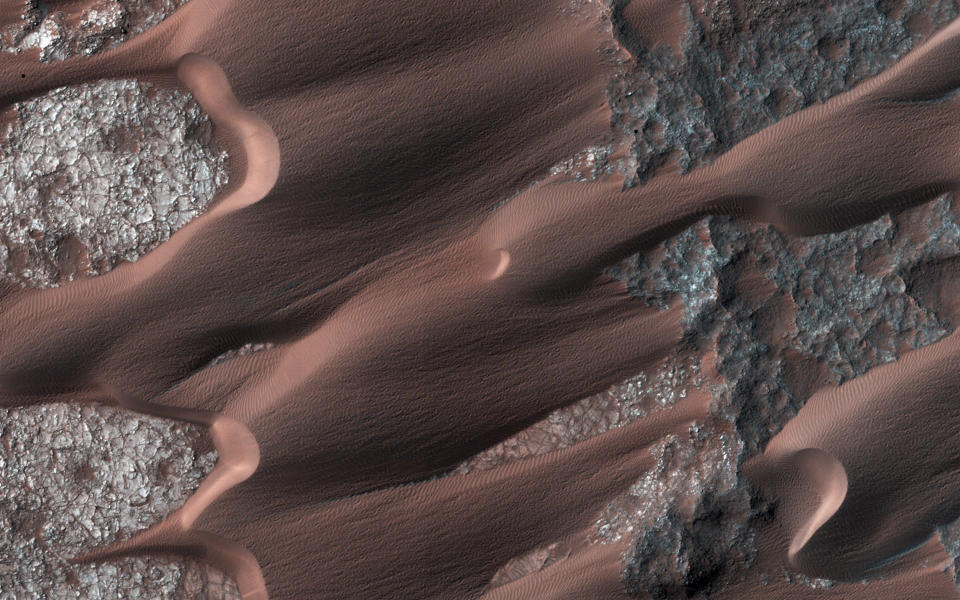 <p>Nili Patera, one of the most active dune fields on the planet Mars, is shown in this handout photo taken by NASA’s Mars Reconnaissance Orbiter March 1, 2014. By monitoring the sand dune changes, NASA can determine how winds vary seasonally and year to year. (Photo: NASA/JPL-Caltech/Univ. of Arizona/Reuters) </p>