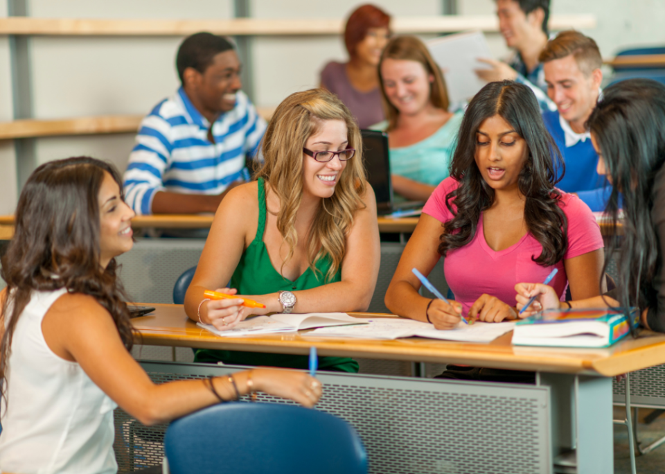 Four college students completing group work in class.