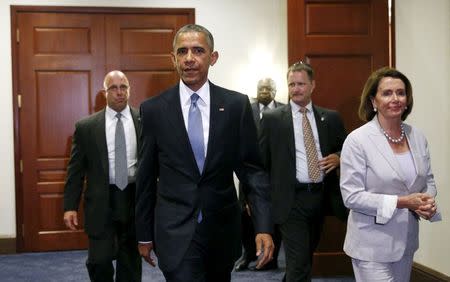 U.S. President Barack Obama, with House Democratic leader Nancy Pelosi at his side, walks from a meeting room after making a last-ditch appeal to House Democrats to support a package of trade bills vital to his Asian policy agenda in the U.S. Capitol in Washington June 12, 2015. REUTERS/Kevin Lamarque