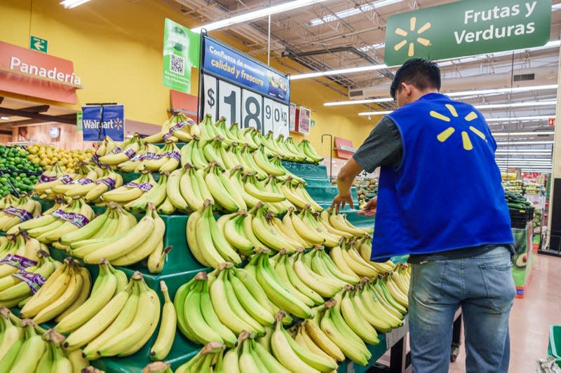 A Walmart employee replenishes his supply of bananas. - Image: Jeffrey Greenberg/Universal Images Group (Getty Images)