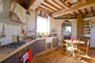 <p>The kitchen has plenty of rustic charm with its wooden floors and beamed ceiling. (Airbnb) </p>