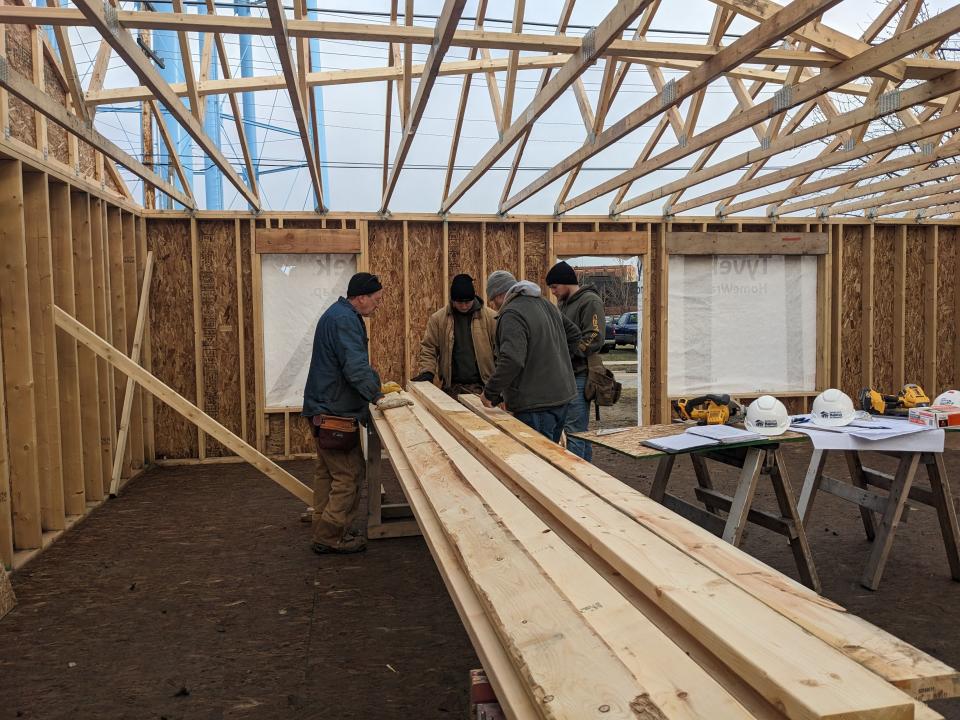 Volunteers work on the inside of a Habitat for Humanity home.